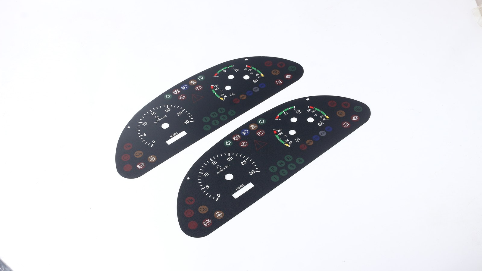 Real product crop of automotive dashboard overlay samples for adhesive landing and housing fit checks