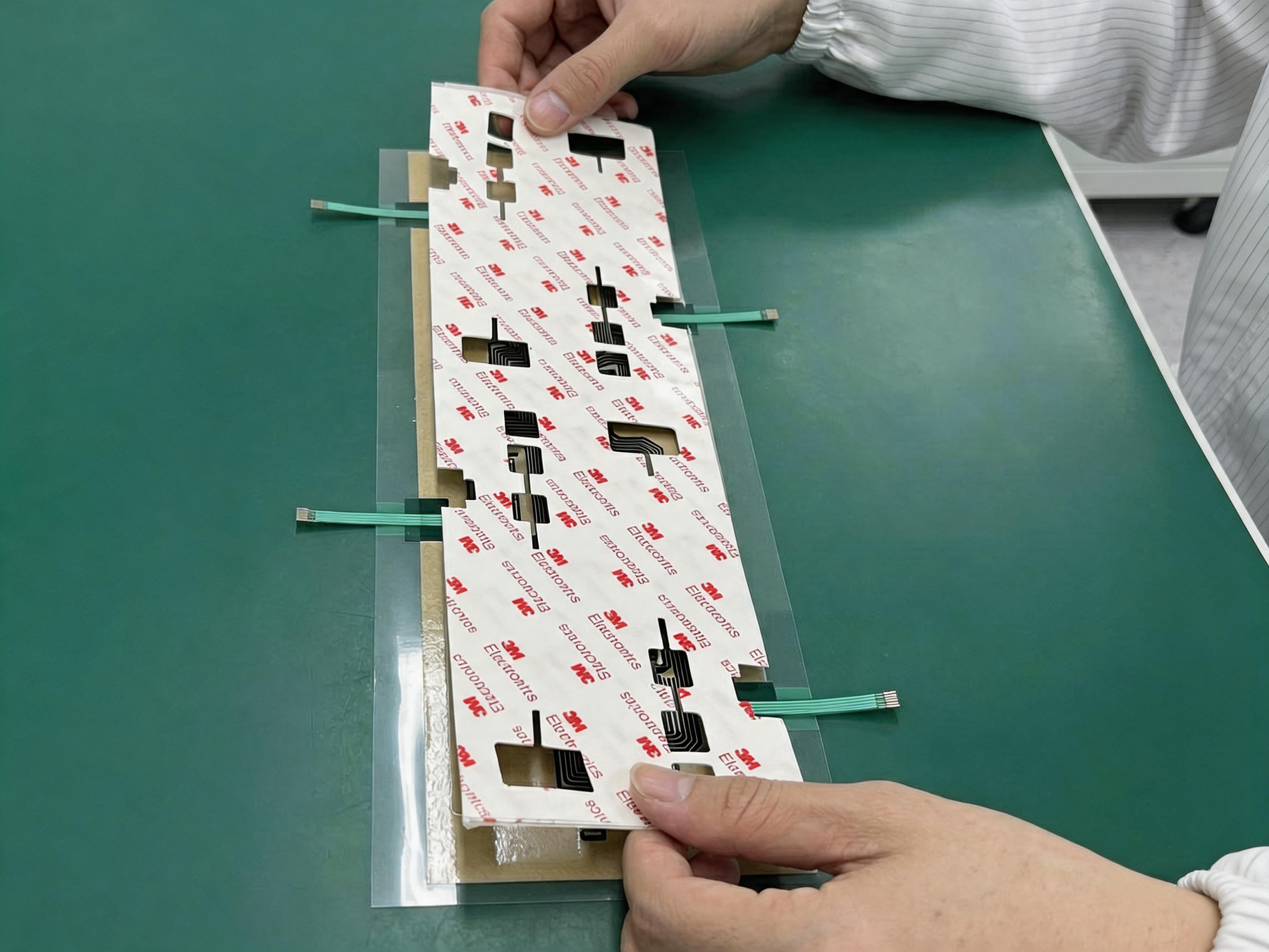 Factory assembly check for a custom membrane switch with adhesive backing and flexible tails