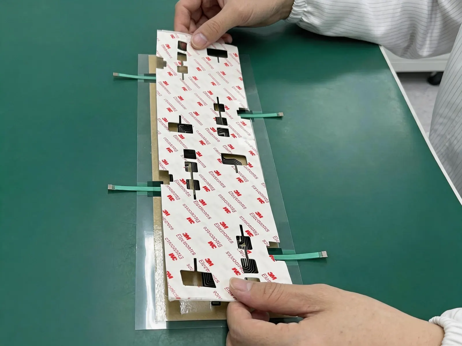 Membrane switch assembly with adhesive and flexible tails