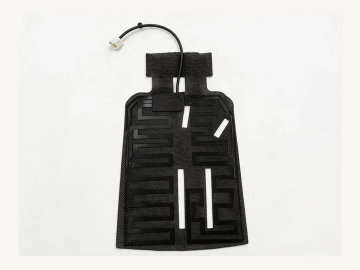 Custom flexible heating film element with routed heating tracks and cable connector